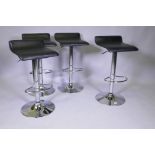 A set of four contemporary chromed metal and leatherette adjustable bar stools