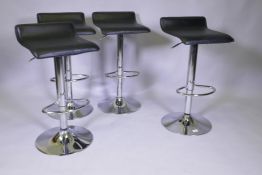 A set of four contemporary chromed metal and leatherette adjustable bar stools