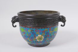 A Chinese bronze censer with two dragon mask handles and cloisonne lotus flower decoration,