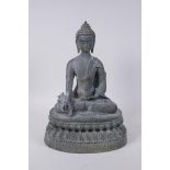 A Tibetan bronze figure of Buddha seated on a lotus throne with verdigris patination, 35cm high