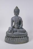 A Tibetan bronze figure of Buddha seated on a lotus throne with verdigris patination, 35cm high