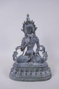 A Sino Tibetan bronze figure of Buddha seated and holding a vajra and stupa, with ver de gris