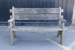 A weathered wood garden bench, 130cm wide