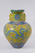 A Chinese Fahua porcelain vase with two handles, decorated with a phoenix, dragon and flowers in the