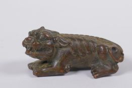 A Japanese style bronze okimono in the form of a temple lion, 7cm long