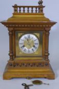 A walnut cased mantel clock, with brass dial and silvered chapter ring, the 14 day movement striking
