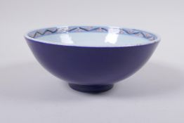 A Chinese porcelain bowl with blue, white and red dragon decoration to the interior and a blue