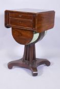 A C19th rosewood work table with drop leaf top over two drawers, the upper fitted with a pull out