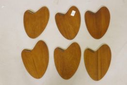 A set of six mid century Danish rosewood veneered coasters marked PV Vamo, 24cm long