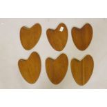 A set of six mid century Danish rosewood veneered coasters marked PV Vamo, 24cm long