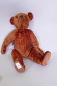 An antique red plush hump back teddy bear, 46cm long