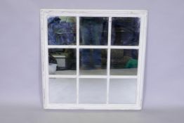 A decorative painted and distressed mirror in the form of a window, 85 x 85cm