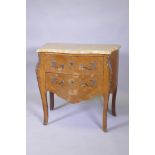 A continental inlaid tulipwood commode with marble top, drawers and serpentine front, raised on