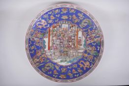 A Chinese famille rose porcelain charger with decorative panel depicting an emperor's court, with in