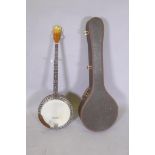 A 1950s Kay five string banjo, with a carry case, 98cm long, 34cm diameter