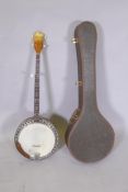 A 1950s Kay five string banjo, with a carry case, 98cm long, 34cm diameter