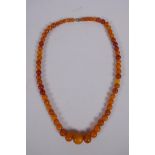 A graduated amber bead necklace, 54cm long