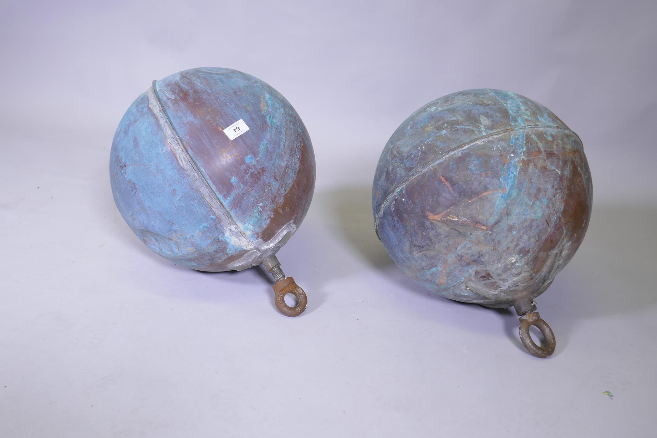 A pair of large copper floats, by repute ex Ancaster brewery, 50cm high