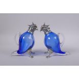 A pair of silver plated and blue glass cockatoo claret jugs, 16cm high