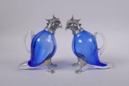 A pair of silver plated and blue glass cockatoo claret jugs, 16cm high