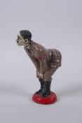 A cold painted metal figural pin cushion, 12cm high
