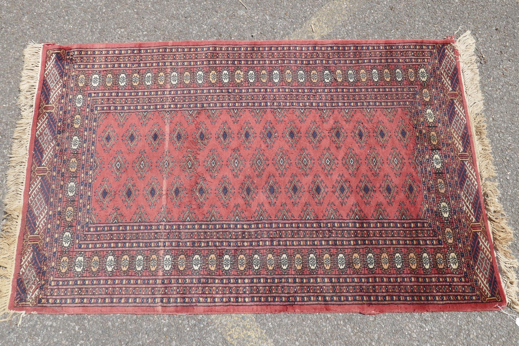 A Turkish terracotta ground wool rug with all over geometric design, 98 x 154cm