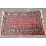 A Turkish terracotta ground wool rug with all over geometric design, 98 x 154cm