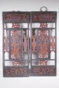 An antique pair of Chinese carved and stained hardwood panels, decorated with figures in a