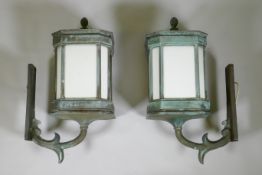 A large pair of early C20th bronze wall lanterns, well patinated and wired for electricity, 75cm