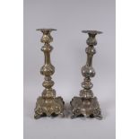 A pair of repousse plated white metal candlesticks, 36cm high