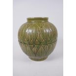 An oriental olive glazed porcelain jar with incised lotus leaf decoration, 23cm high