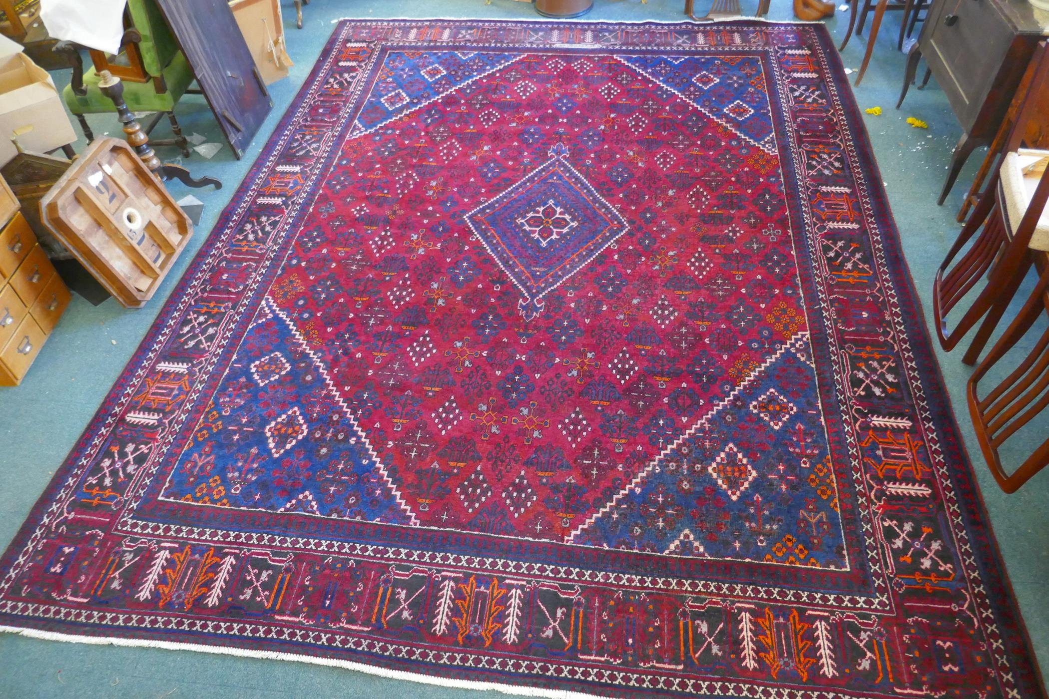 A claret and blue ground Persian Joshaghan tribal carpet with traditional medallion design, - Image 2 of 7