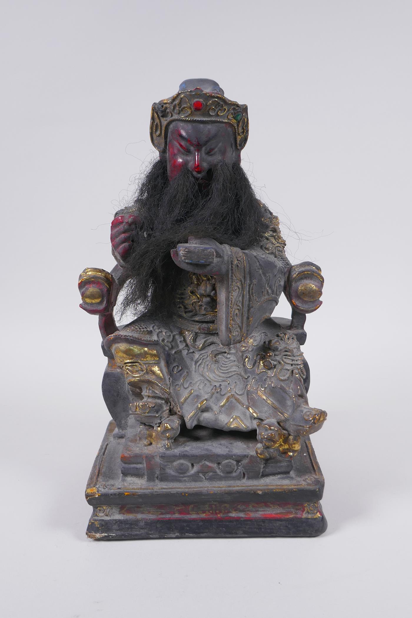 A Chinese carved, lacquered and gilt figure of a seated emperor, 28cm high