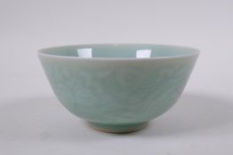 A Chinese celadon glazed porcelain rice bowl, with underglaze carp and lotus flower decoration,