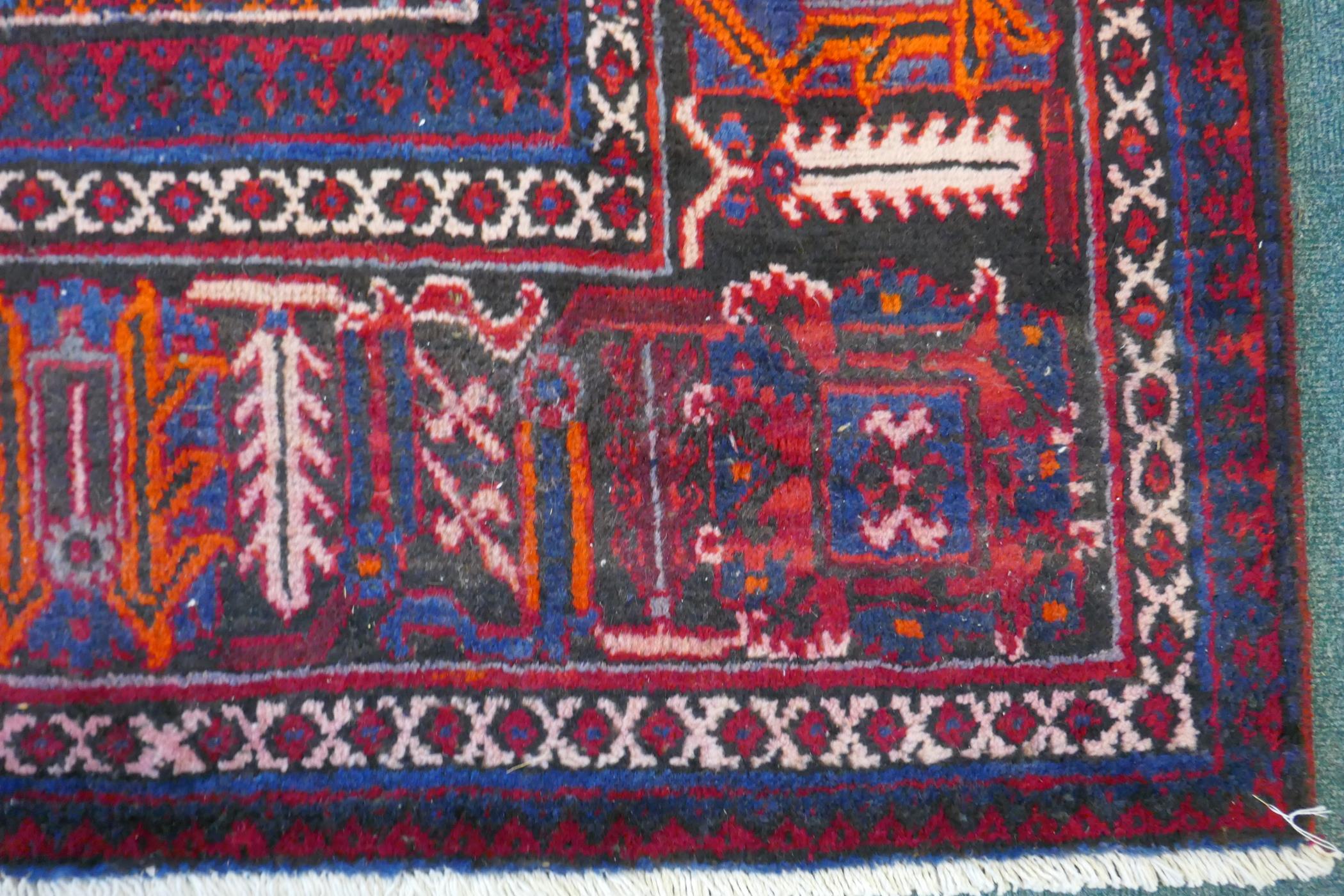 A claret and blue ground Persian Joshaghan tribal carpet with traditional medallion design, - Image 6 of 7