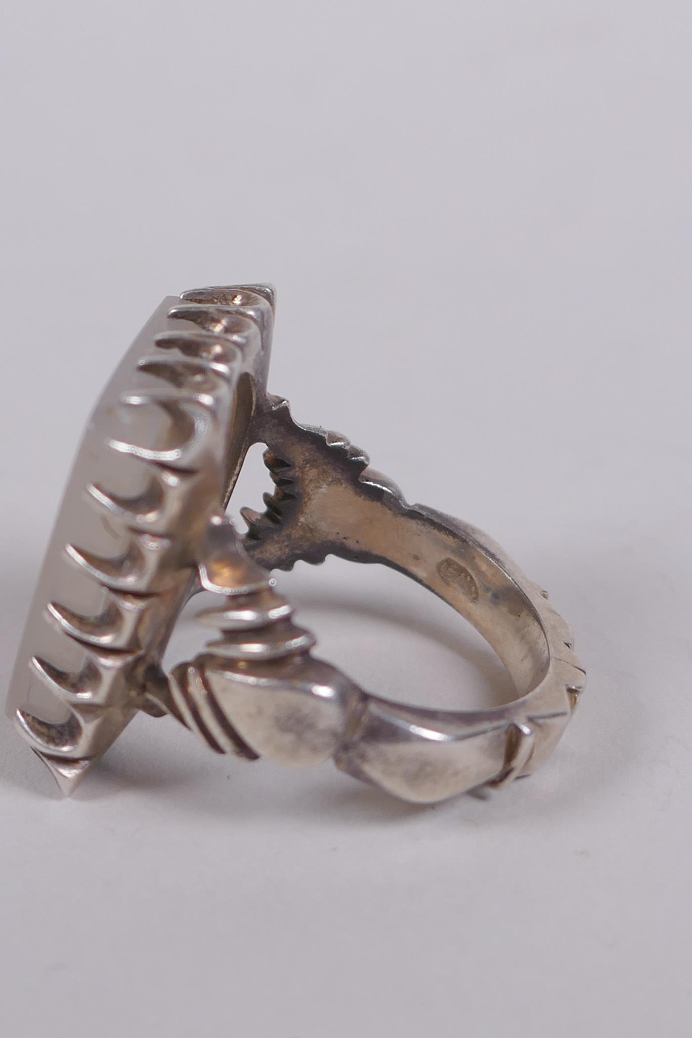 An Islamic white metal ring set with an intaglio seal carved with Islamic script, marks to interior, - Image 3 of 4