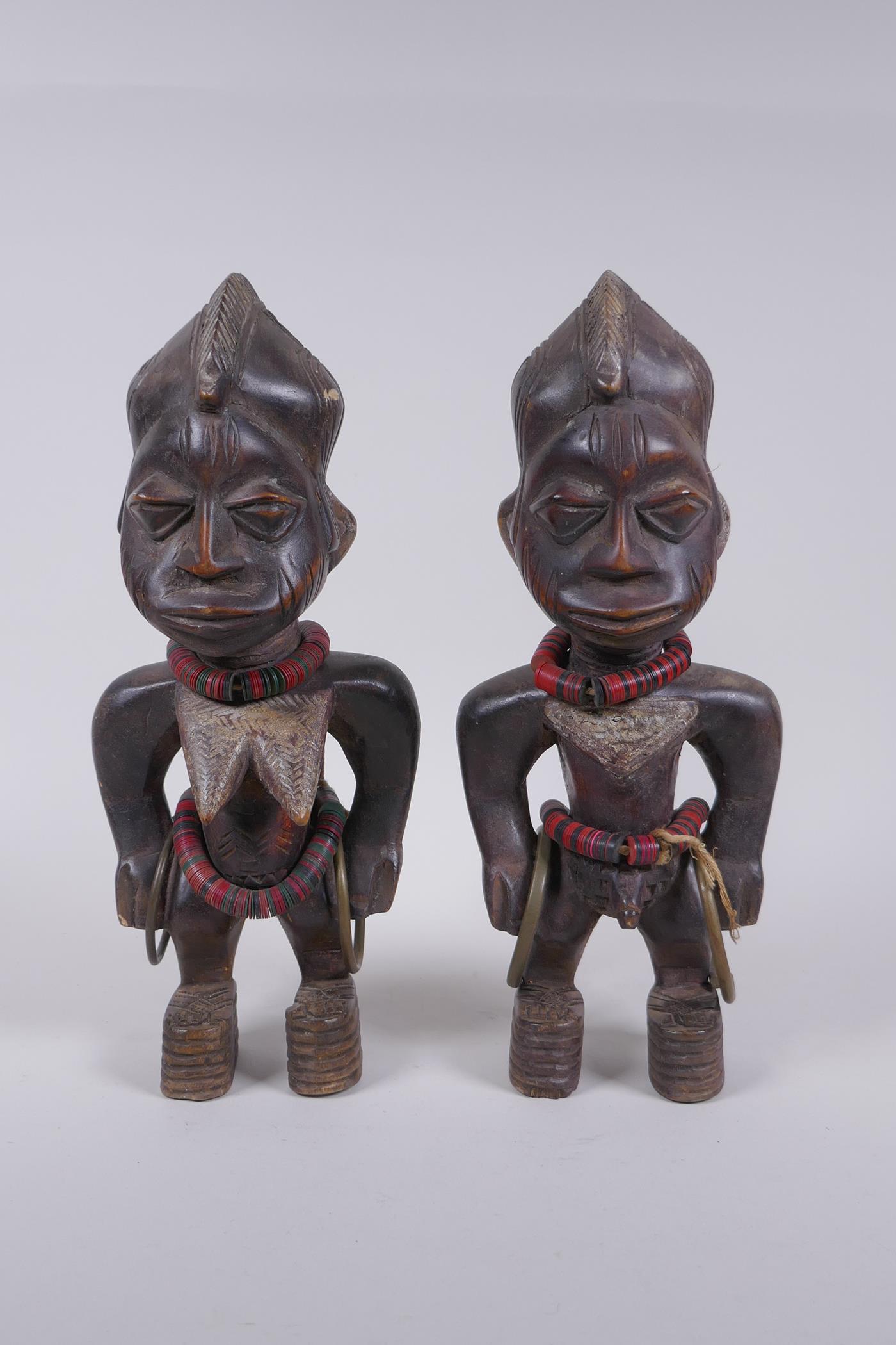 A pair of African Yoruba tribe carved wood Ere Ibeji figures, 28cm high