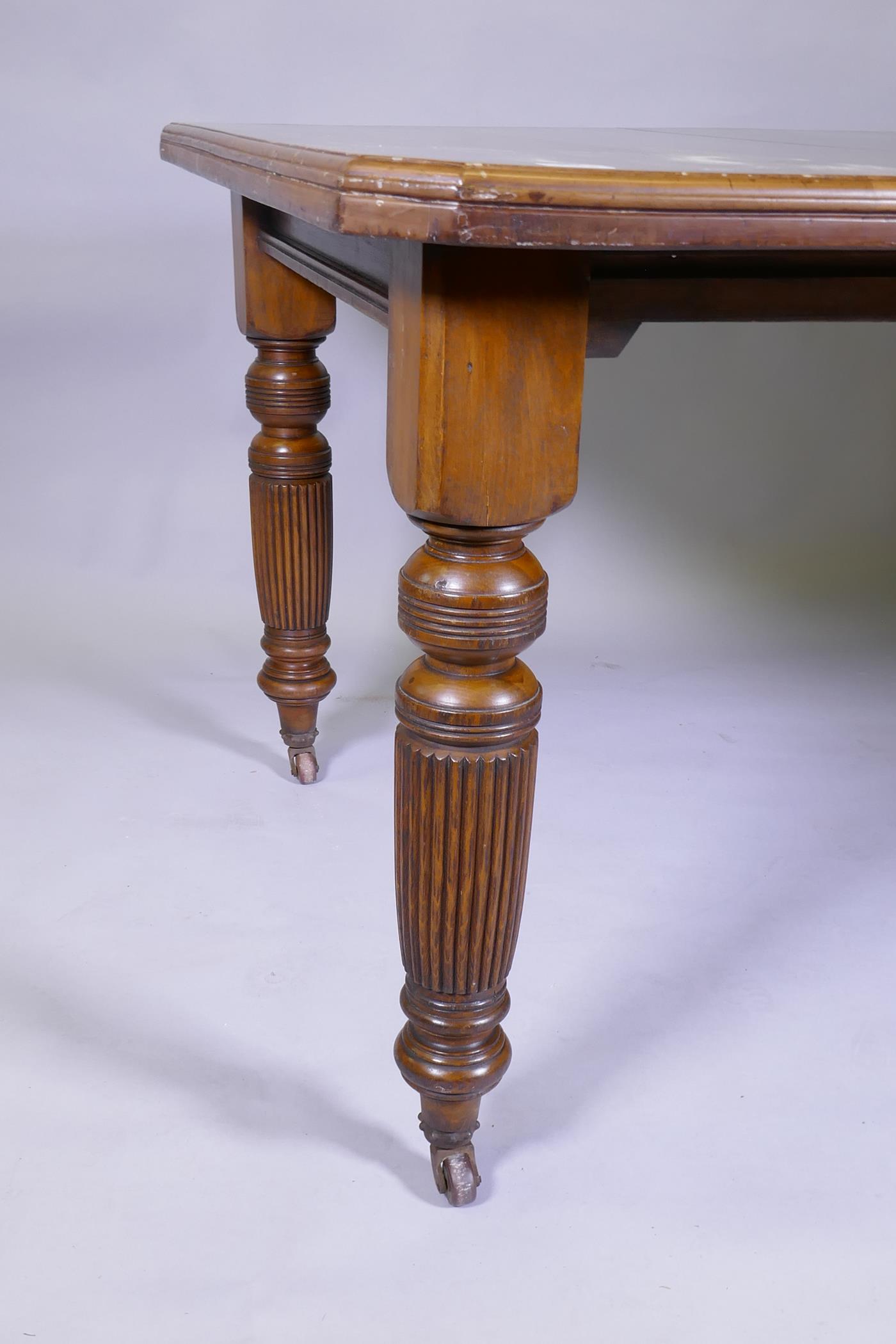 A Victorian mahogany wind out dining table and leaf, on turned and fluted supports, extended 144 x - Image 3 of 3