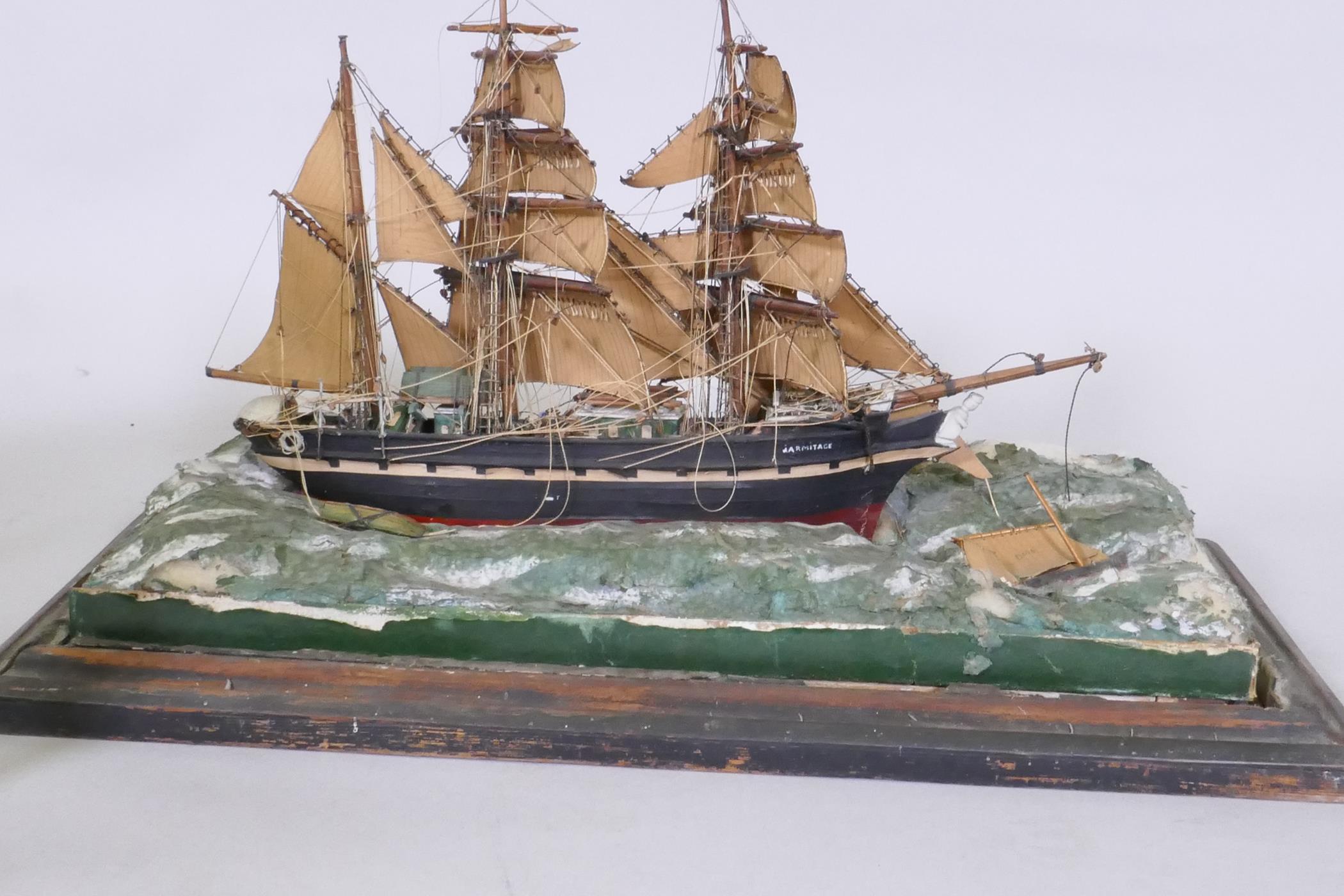 A model of a three masted sailing ship, Armitage in stormy seas, set in a diorama and glass case, AF