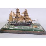 A model of a three masted sailing ship, Armitage in stormy seas, set in a diorama and glass case, AF