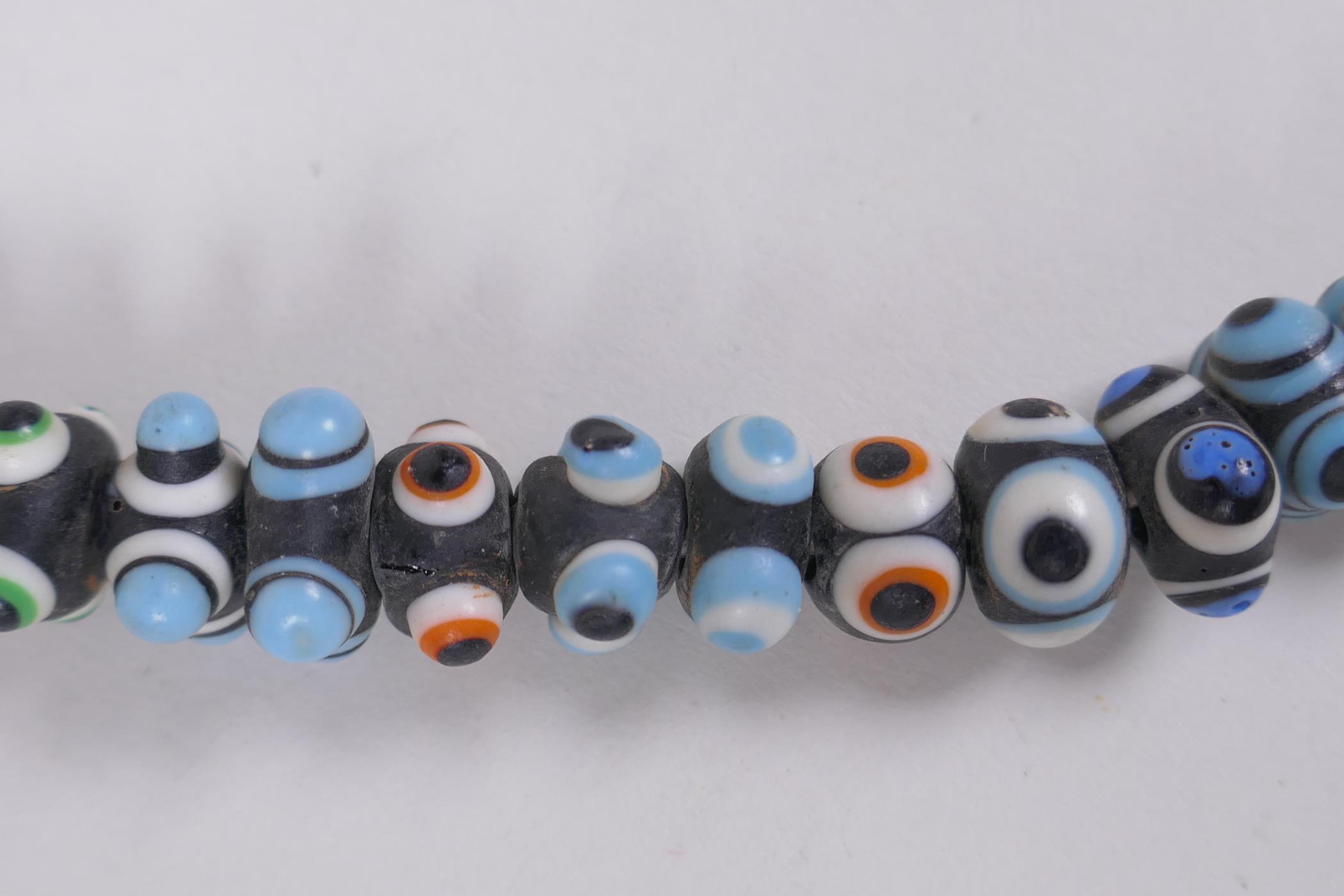 A Venetian glass eye bead necklace, 64cm long - Image 3 of 5