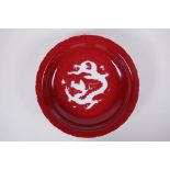 A Chinese sang de boeuf glazed porcelain dish with lobed rim, decorated with a dragon to the bowl,