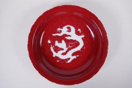 A Chinese sang de boeuf glazed porcelain dish with lobed rim, decorated with a dragon to the bowl,