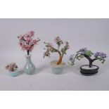Four Chinese hardstone and coloured glass trees, largest 23cm high
