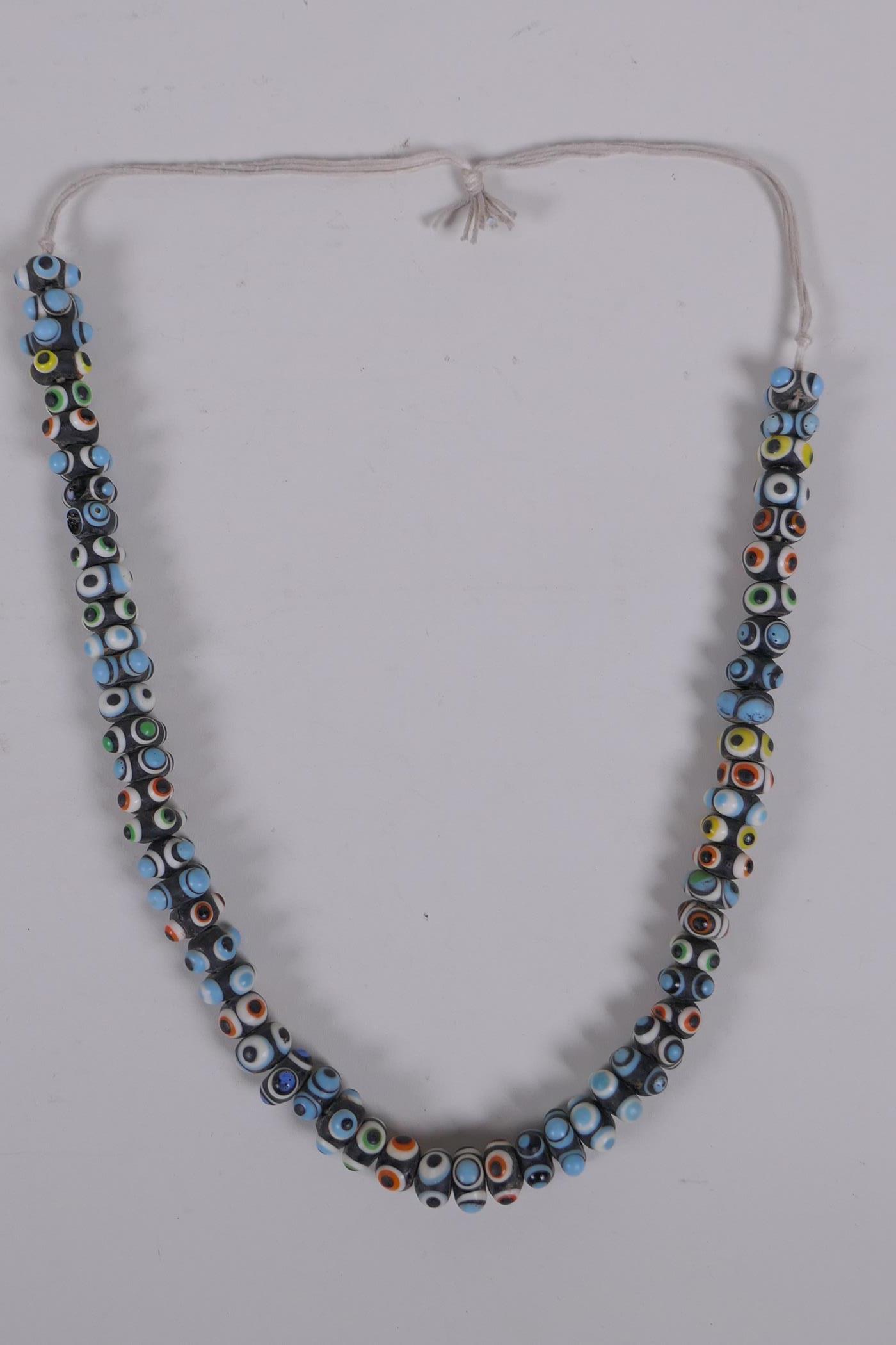 A Venetian glass eye bead necklace, 64cm long