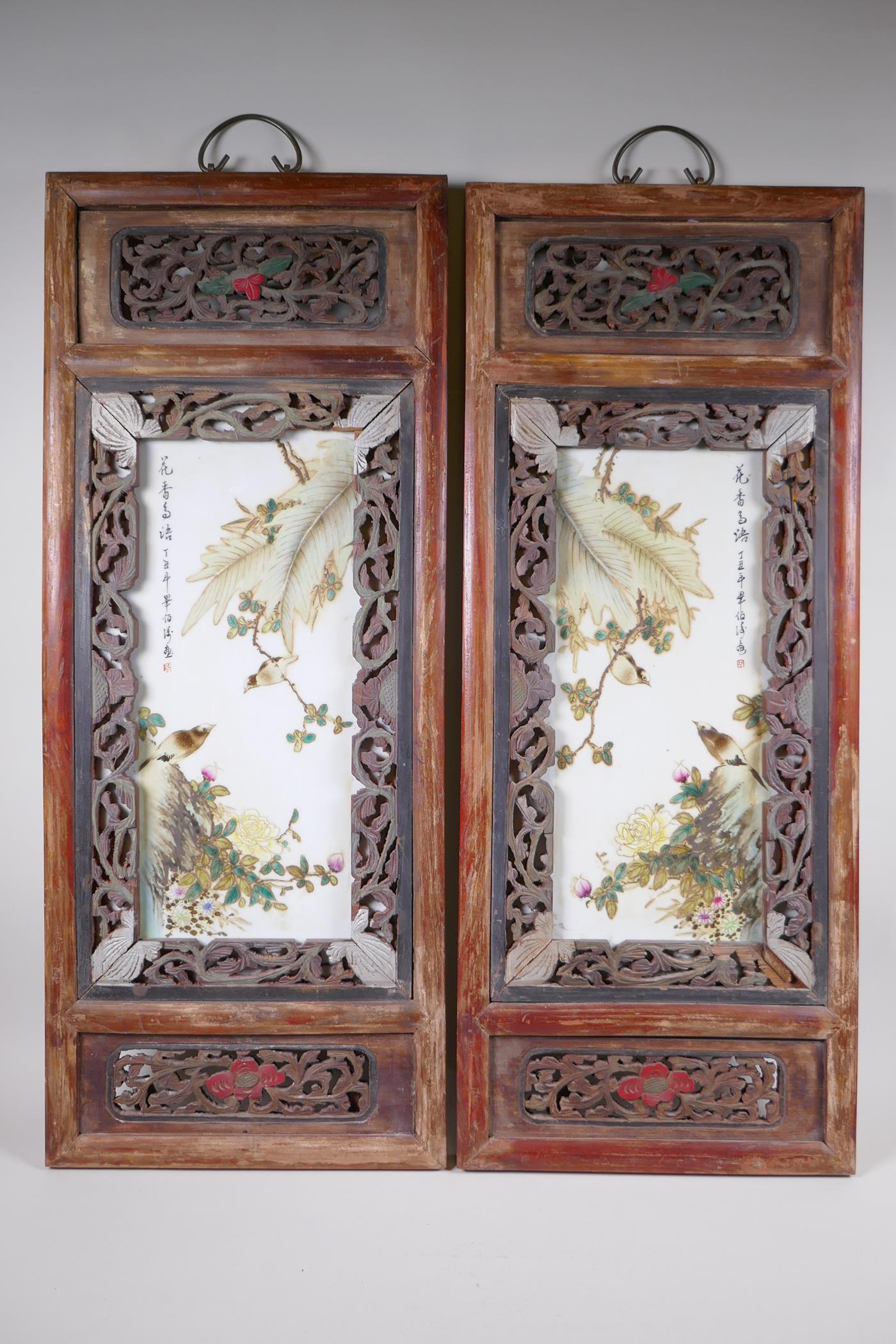 A pair of early C20th Chinese polychrome porcelain panels decorated with birds amongst flowers,