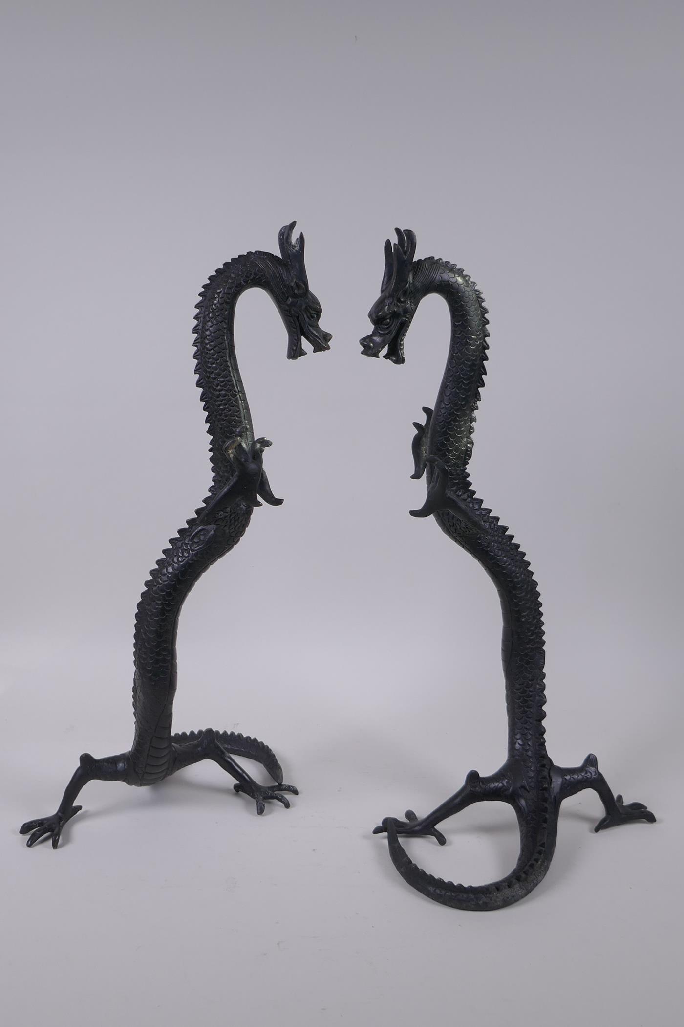 A pair of Chinese bronze dragons, 40cm high