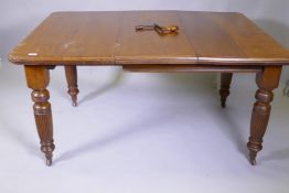 A Victorian mahogany wind out dining table and leaf, on turned and fluted supports, extended 144 x