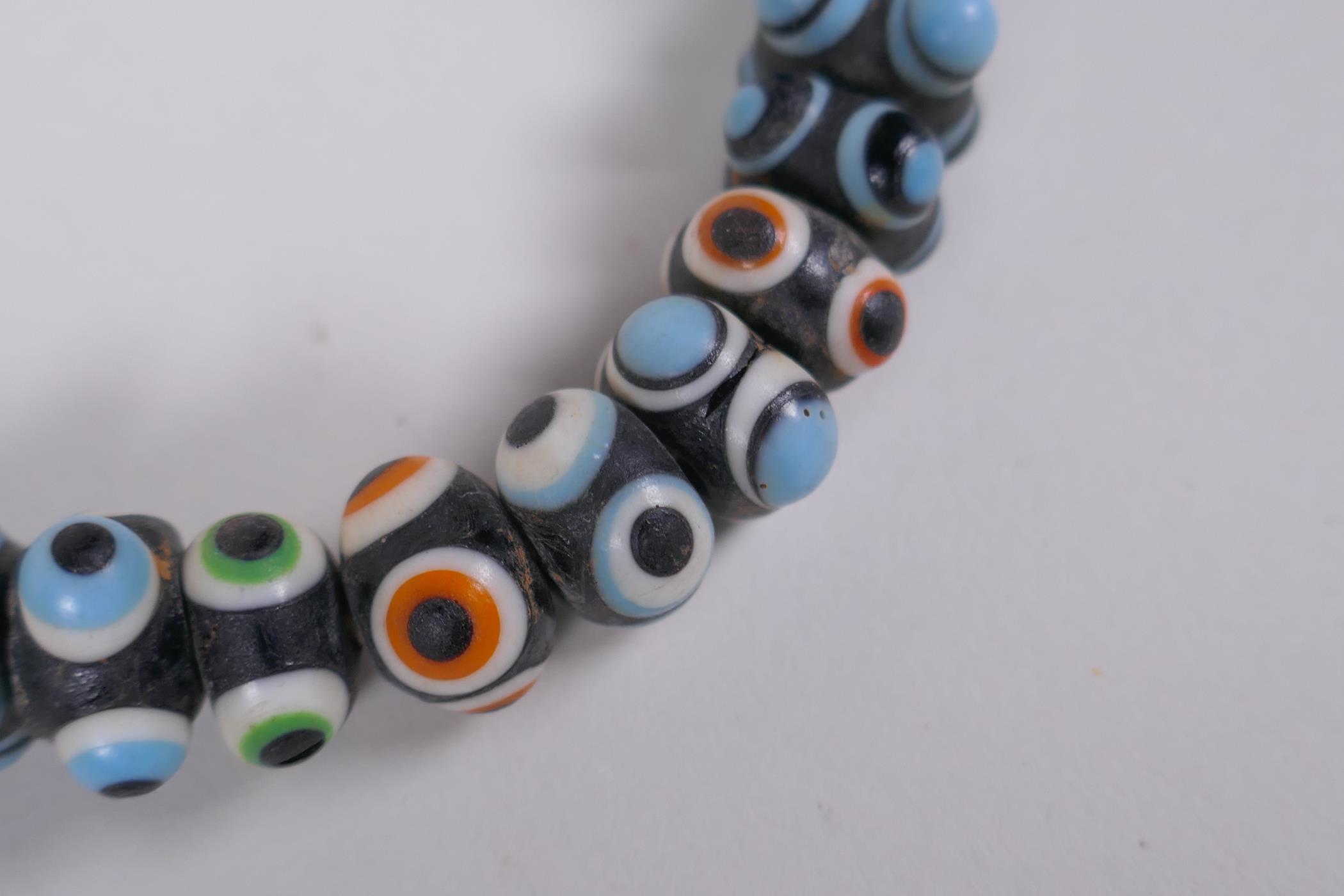 A Venetian glass eye bead necklace, 64cm long - Image 2 of 5