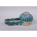 An Islamic faience turquoise glazed oil lamp, 17cm high